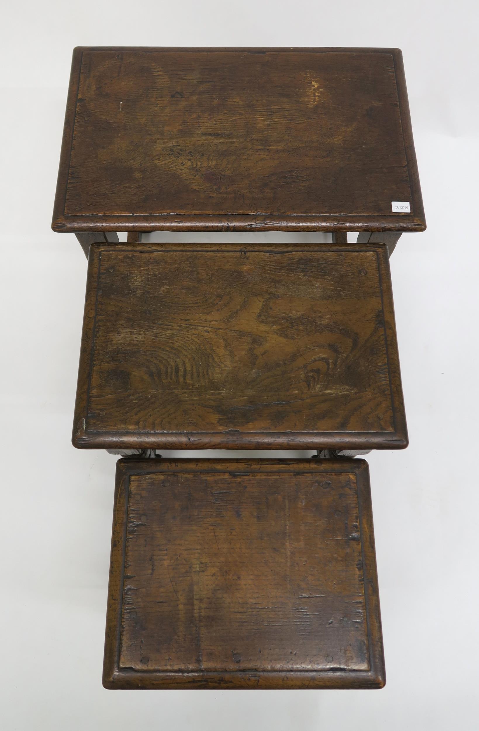 A 20th century stained oak nest of three tables on turned stretched supports, 50cm high x 51cm - Image 2 of 3