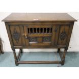 A 20th century stained oak single door side cabinet with carved rose reliefs, 84cm high x 92cm