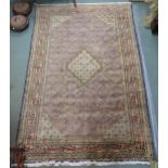 A multicoloured ground Tabriz rug with central medallion, matching spandrels and a pink border,