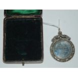 A silver prize medallion "St Andrews Parish Church, 1899-1900 1st Prize, Senior Division, Won by