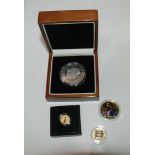 A lot comprising a cased Gibraltar silver five pound coin, two gilded coins and a Concorde gold