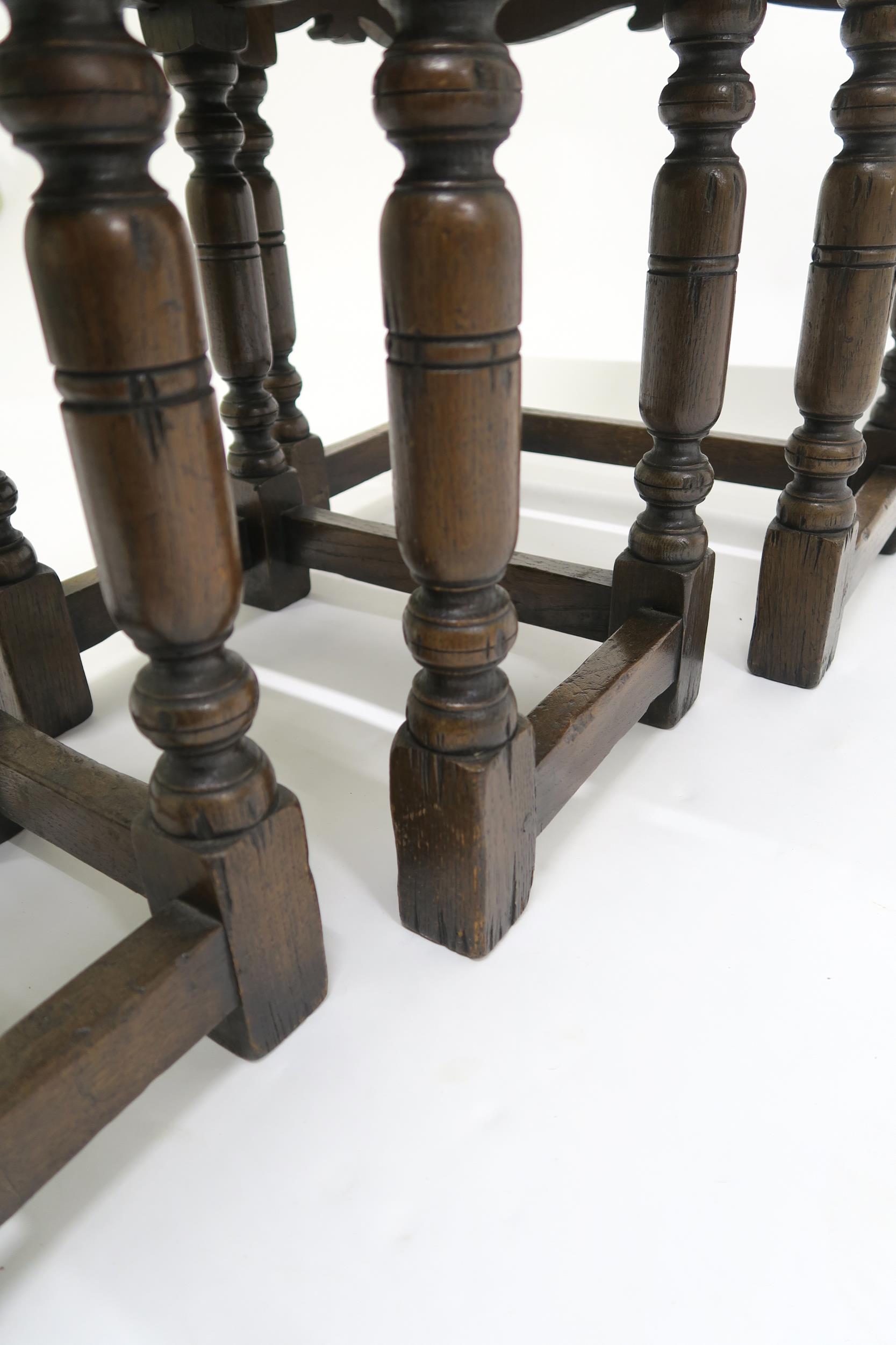 A 20th century stained oak nest of three tables on turned stretched supports, 50cm high x 51cm - Image 3 of 3