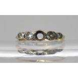 An 18ct gold diamond ring (one diamond missing) the four remaining diamonds have an estimated