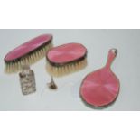 A miniature three-piece silver and enamel dressing table set marked 925 with a white-metal
