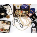 A collection of vintage costume jewellery to include, a string of coral beads and earrings, a grouse