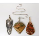 Three American silver and gold plated wire wrapped mineral pendants to include pyrites, fossilized