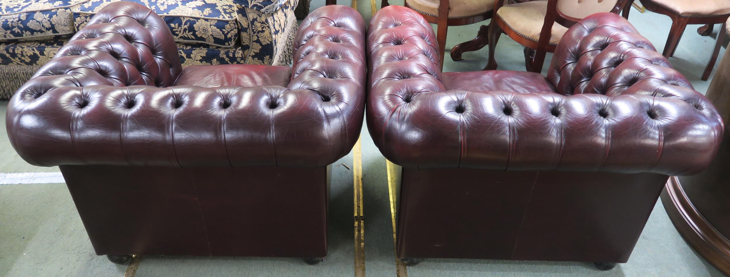 A pair of contemporary oxblood leather upholstered chesterfield club chairs, 70cm high x 102cm - Image 3 of 4