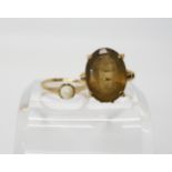 A 9ct gold smoky quartz ring, size O1/2, and a 9ct pearl ring, size N1/2, weight combined 10.6gms