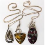 Three American designer pendants by Tom Burns, of Vermont, set with blue and gold tiger's eye,