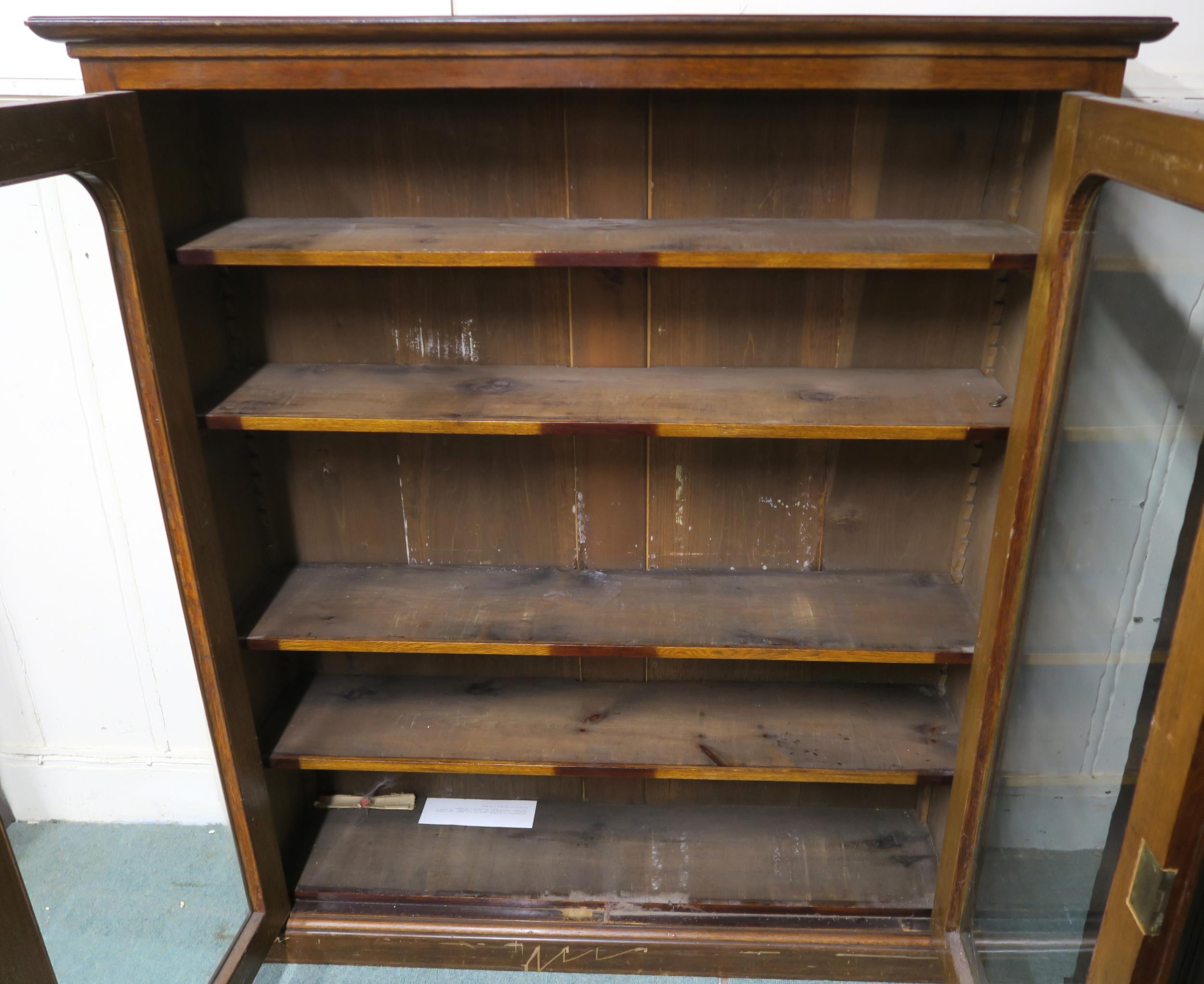 A 20th century stained oak glazed two door bookcase, 147cm high x 127cm wide x 32cm deep Condition - Image 2 of 5