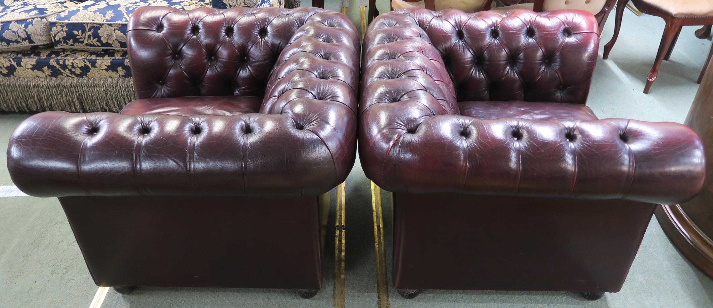 A pair of contemporary oxblood leather upholstered chesterfield club chairs, 70cm high x 102cm - Image 2 of 4