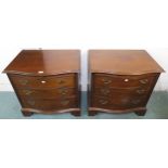 A pair of 20th century mahogany serpentine front three drawer chests, 69cm high x 71cm wide x 48cm