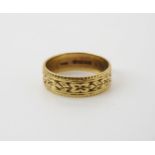 An 18ct gold flower engraved wedding ring size O, weight 4gms Condition Report:Available upon