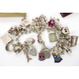 An extensive silver charm bracelet, and a collection of silver and costume jewellery Condition