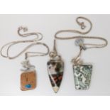 Three American designer pendants made by Tom Burns, all three signed, two with silver chains, to