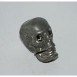 A metal vesta modelled as a human skull, 4.5cm high Condition Report:Available upon request