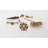 A collection of yellow metal items to include a turquoise and pearl ivy leaf brooch, an opal and