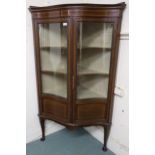 An Edwardian mahogany glazed serpentine front corner cabinet on cabriole supports, 168cm high x 97cm