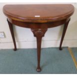 A 20th century mahogany demi lune fold over card table on cabriole supports, 73cm high x 81cm wide x