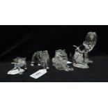 Four Swarovski figures including a standing lion, a seated lion, a lioness and Cheetah, all with