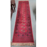 A red ground Bokhara style runner, 273cm long x 69cm wide Condition Report:Available upon request