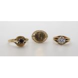 Three 9ct gold rings, garnet, size R1/2, faux coin size Q, and clear gem, size N. Combined weight