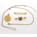 A collection of 9ct gold items to include two chains, a medallion, and two brooches, weight combined