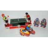 A Chinese tin plate clockwork model of a table tennis match, 23cm wide, two Chinese clockwork robots