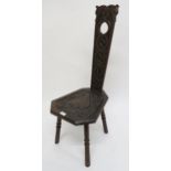 A 20th century oak spinning chair with extensive Celtic carvings Condition Report:Available upon