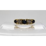 An 18ct gold sapphire and diamond ring in scroll mount, size R1/2, weight 5.1gms Condition Report: