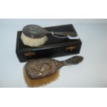 A cased silver-backed brush, Birmingham 1906 and another silver-backed brush (2) Condition Report: