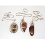 Three silver designer pendants by Tom Burns of Vermont to include ammolite, jasper with pyrites
