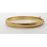 A 9ct gold engraved bangle, weight 12.5gms Condition Report:Available upon request