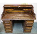 A 20th century oak roll top pedestal desk, 116cm high x 124cm wide x 82cm deep Condition Report: