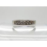 A platinum eternity ring set with seven diamonds with a combined estimated approx total of 0.