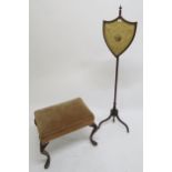 A Victorian mahogany shield back pole screen and an upholstered footstool on shaped mahogany
