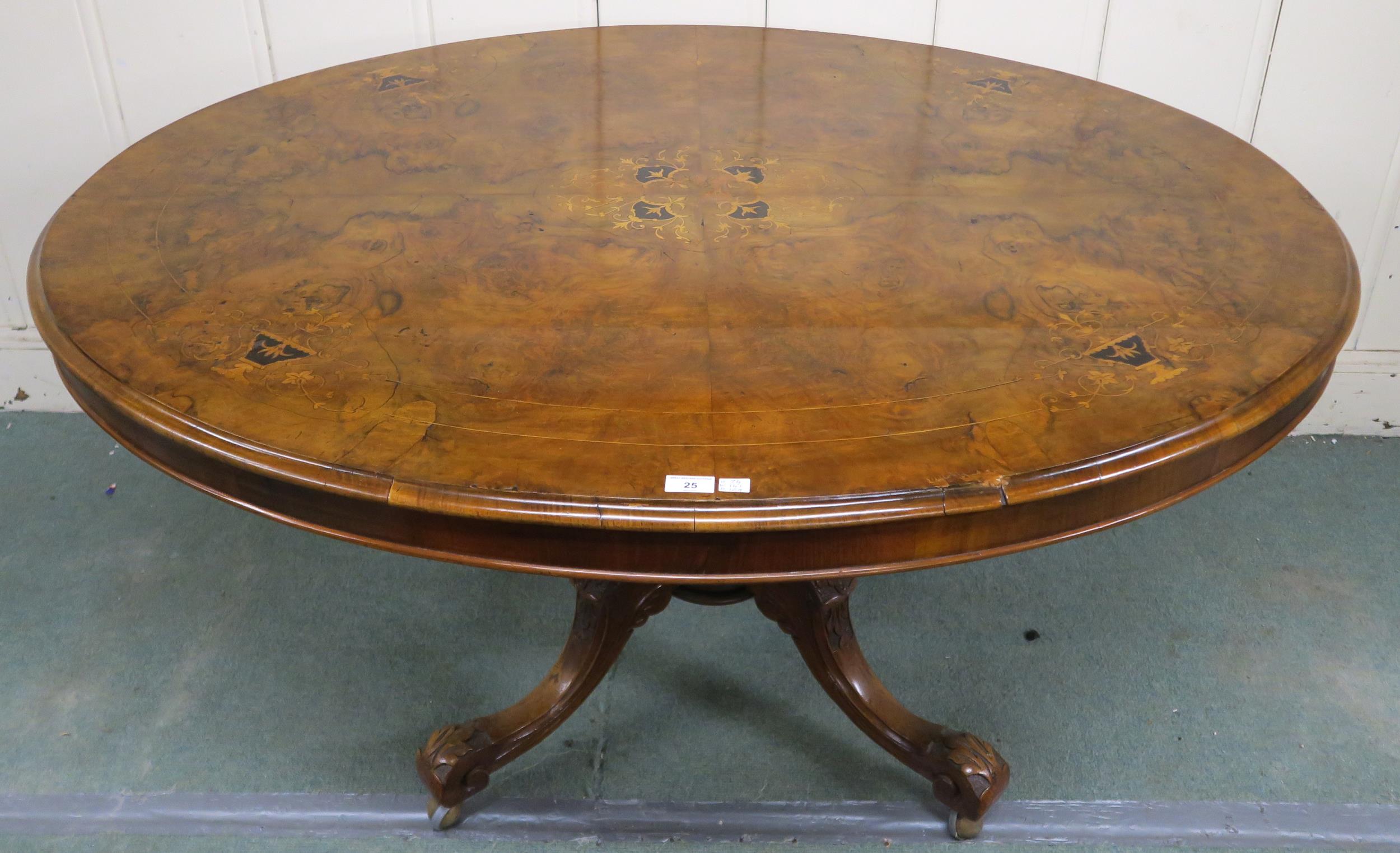 A Victorian burr walnut inlaid oval tilt top breakfast table on carved quadrupedal base, 74cm high x