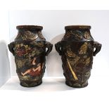 A pair of brown glazed pottery vases with raised decoration of figures etc Condition Report: