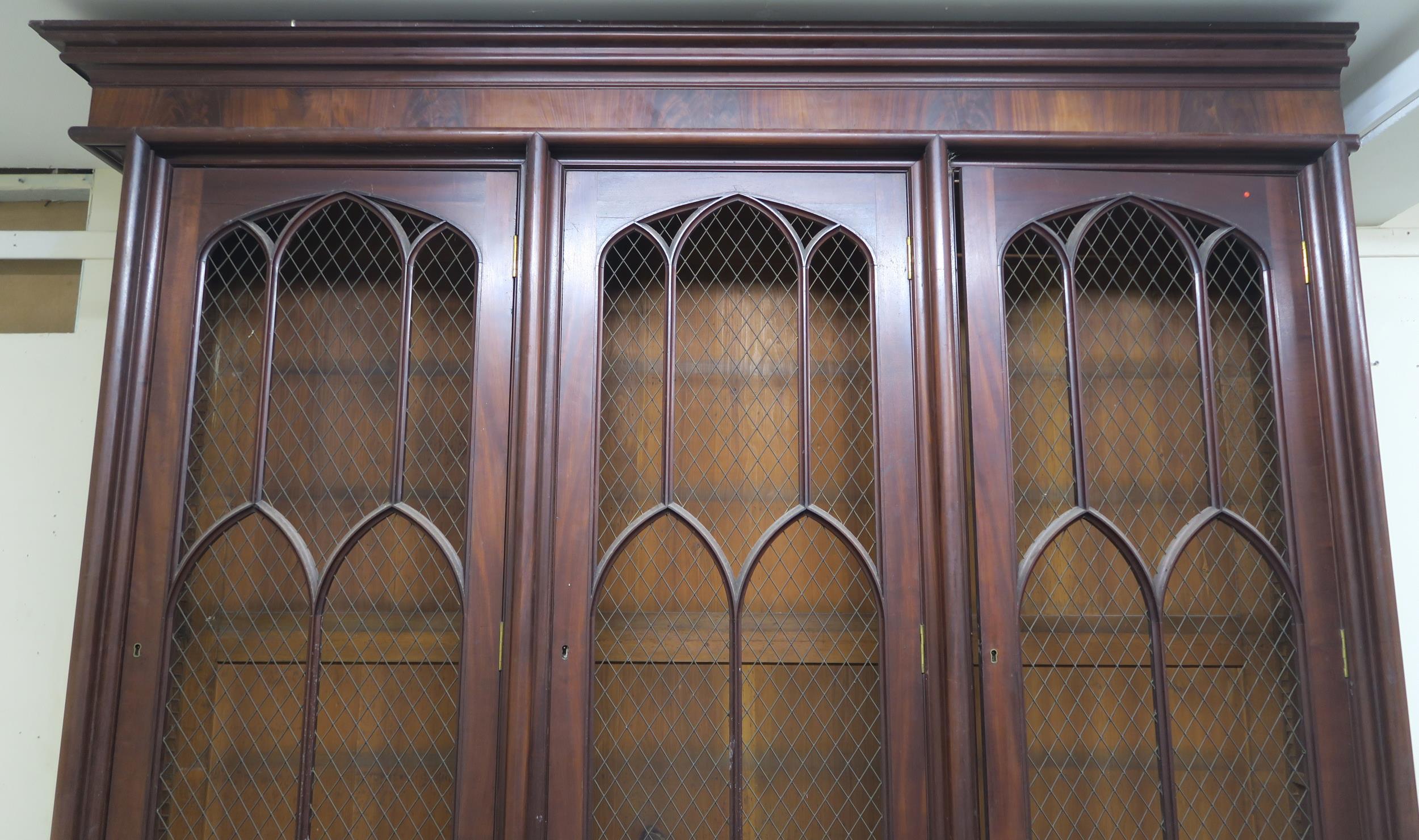 A VICTORIAN MAHOGANY GOTHIC REVIVAL BOOKCASE, with three pierced grill doors above three stylized - Image 3 of 10