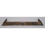AN ARTS AND CRAFTS HAMMERED COPPER FENDER with sinous foliage and inset with ceramic medallions,
