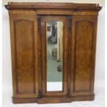 A VICTORIAN BURR WALNUT BREAKFRONT TRIPLE DOOR WARDROBE