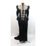 A VICTORIAN MOURNING DRESS IN BLACK FLORAL patterned crepe with applied white lace to black velvet