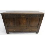 AN 18TH CENTURY OAK COFFER the hinged lid above a carved foliate frieze divided by I.P monogram,