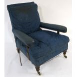 A VICTORIAN HOWARD & SONS LTD OAK FRAMED UPHOLSTERED ARMCHAIR on turned front supports, stamped "