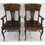 A SET OF SIX EDWARDIAN OAK DINING CHAIRS comprising; two carvers 99cm high and four standard 94cm