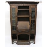 AN OAK ARTS & CRAFTS BUREAU BOOKCASE, with central fall front bureau below open shelves flanked by