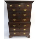 A GEORGE III ELM CHEST ON CHEST the ogee cornice above three short and three long drawers, divided