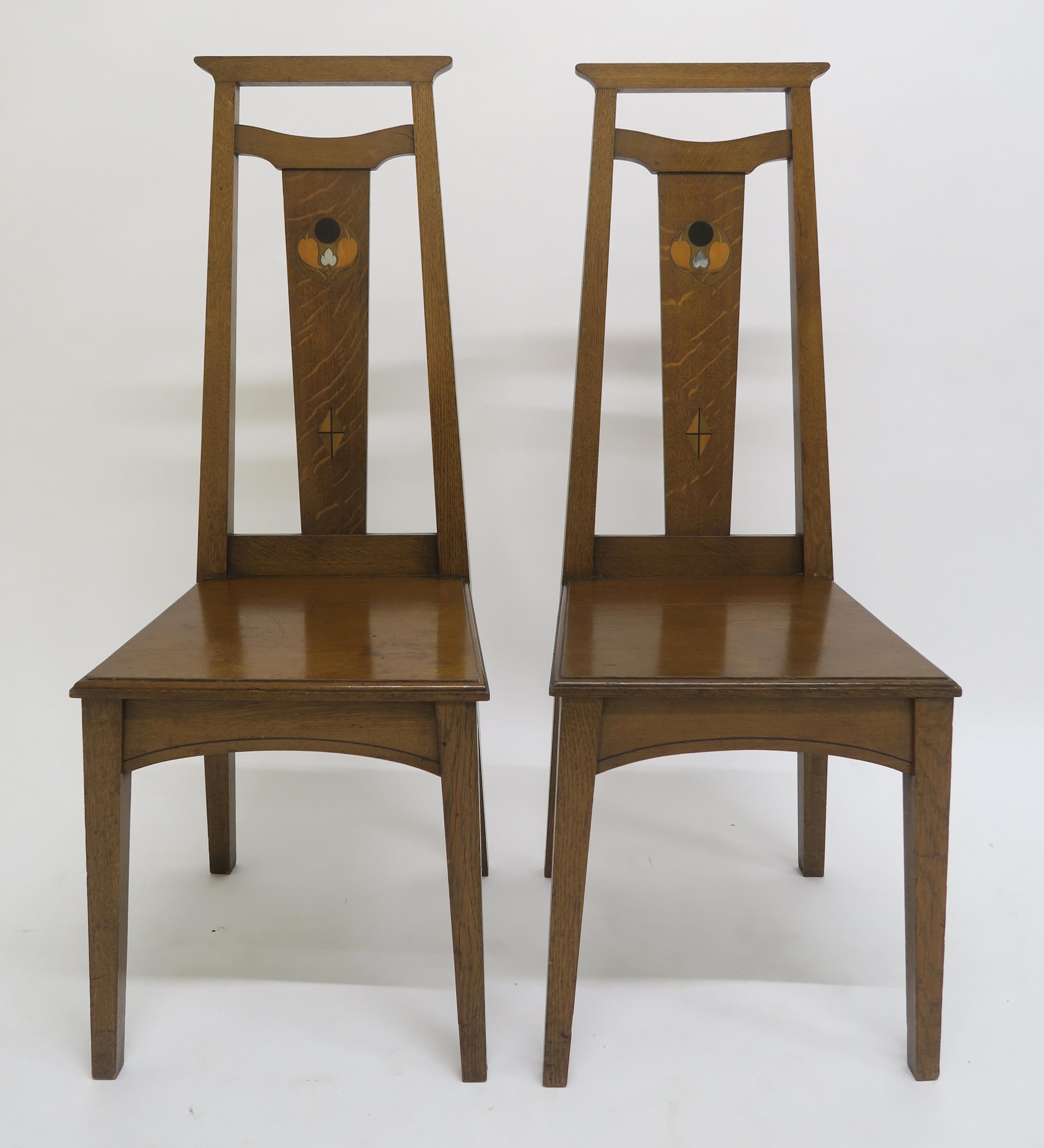 A PAIR OF ARTS AND CRAFTS HALL CHAIRS, each with mother of pearl and fruitwood inlay to splats on