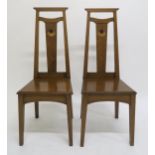 A PAIR OF ARTS AND CRAFTS HALL CHAIRS, each with mother of pearl and fruitwood inlay to splats on