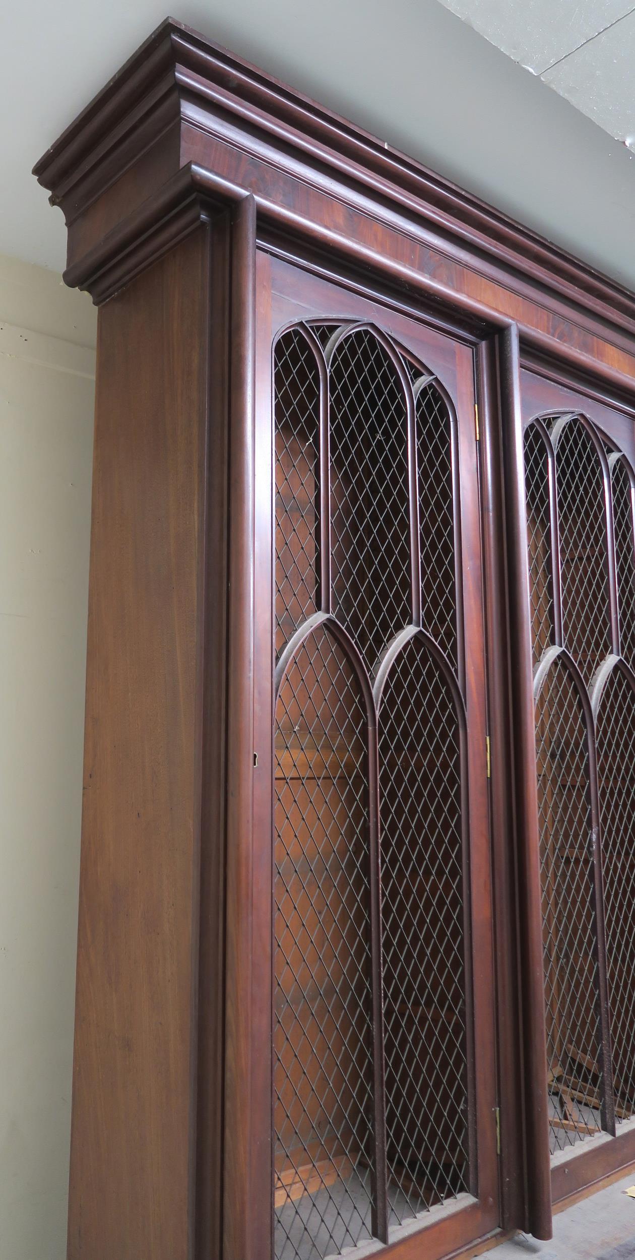 A VICTORIAN MAHOGANY GOTHIC REVIVAL BOOKCASE, with three pierced grill doors above three stylized - Image 5 of 10